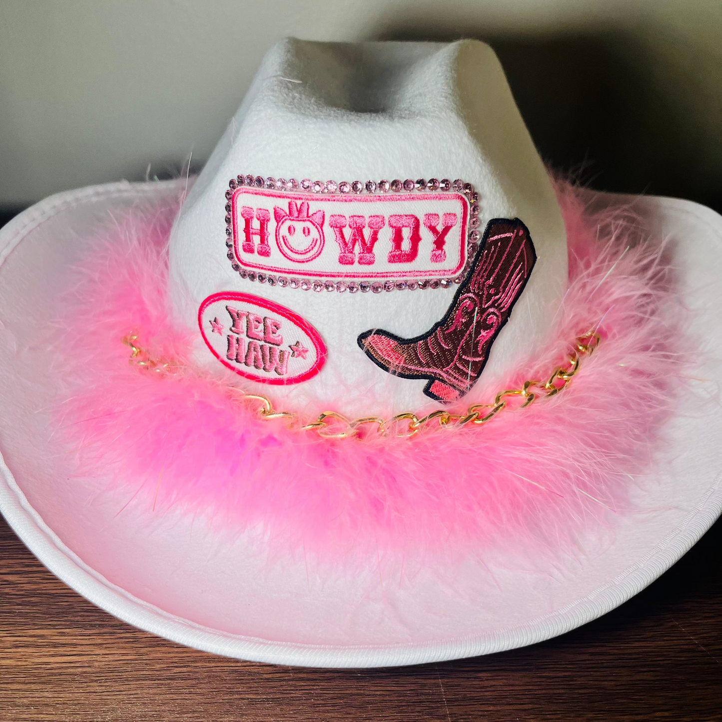 Custom glam cowgirl hat with pink feathers, rhinestones, and personalized western design – perfect for birthdays, festivals, and parties