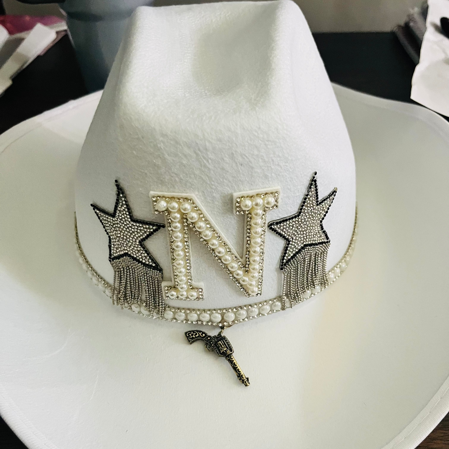 Custom glam cowgirl hat with pink feathers, rhinestones, and personalized western design – perfect for birthdays, festivals, and parties